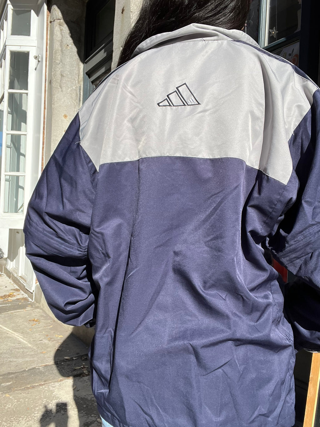 Vintage Adidas windbreaker jacket from Elektra Vintage, featuring classic design and sporty style in a retro look.
