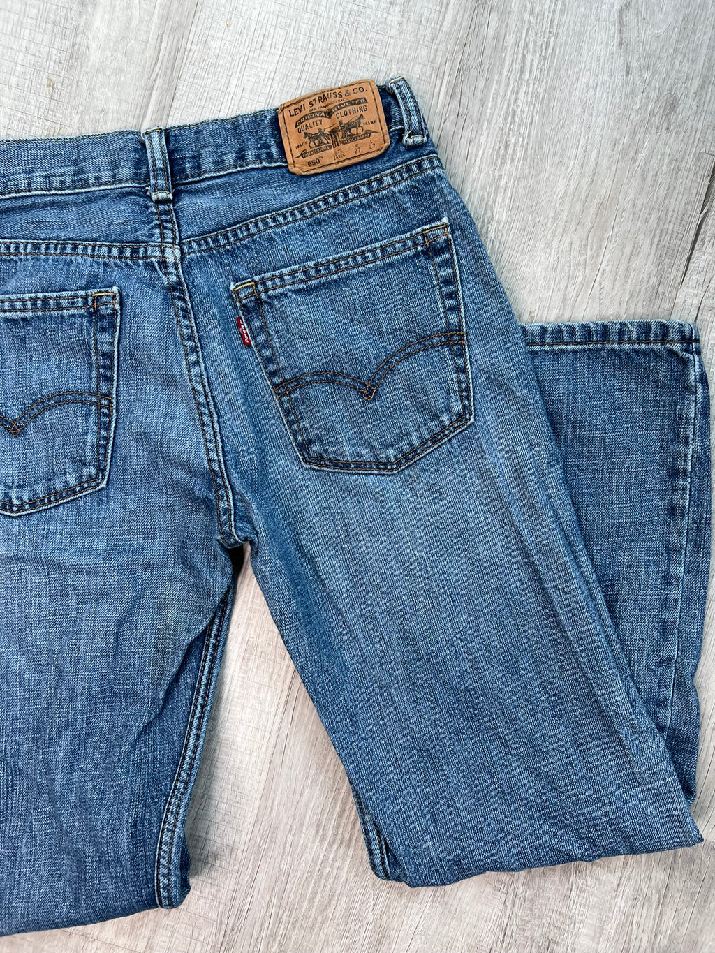 Elektra Vintage women's Levi's 550 medium wash straight fit jeans, showing the classic denim with a relaxed straight-leg style.