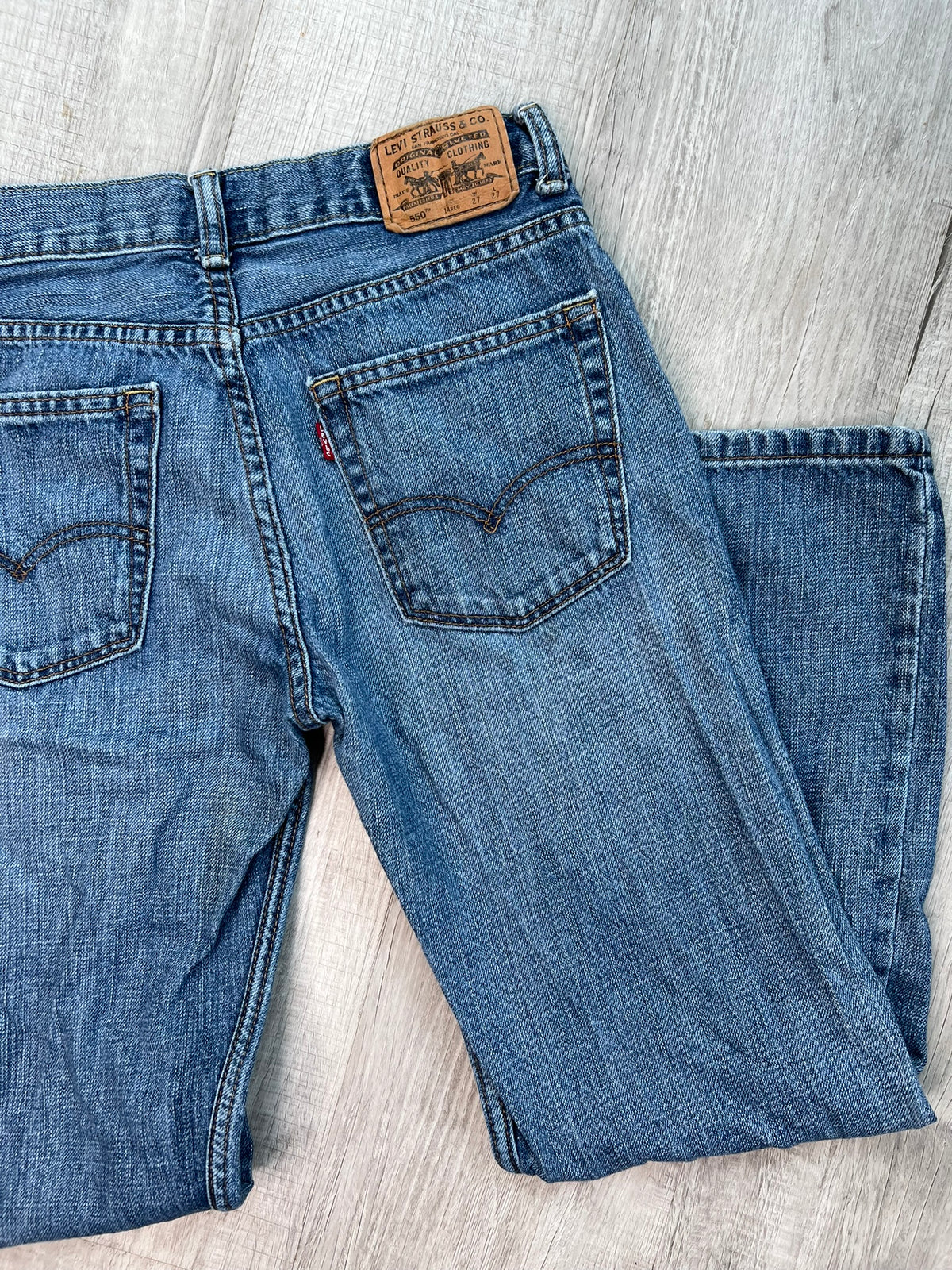 Elektra Vintage women's Levi's 550 medium wash straight fit jeans, showing the classic denim with a relaxed straight-leg style.
