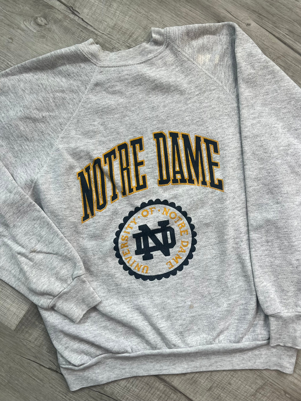 Vintage University of Notre Dame crewneck sweatshirt by Elektra Vintage, featuring a classic university logo on soft fabric.
