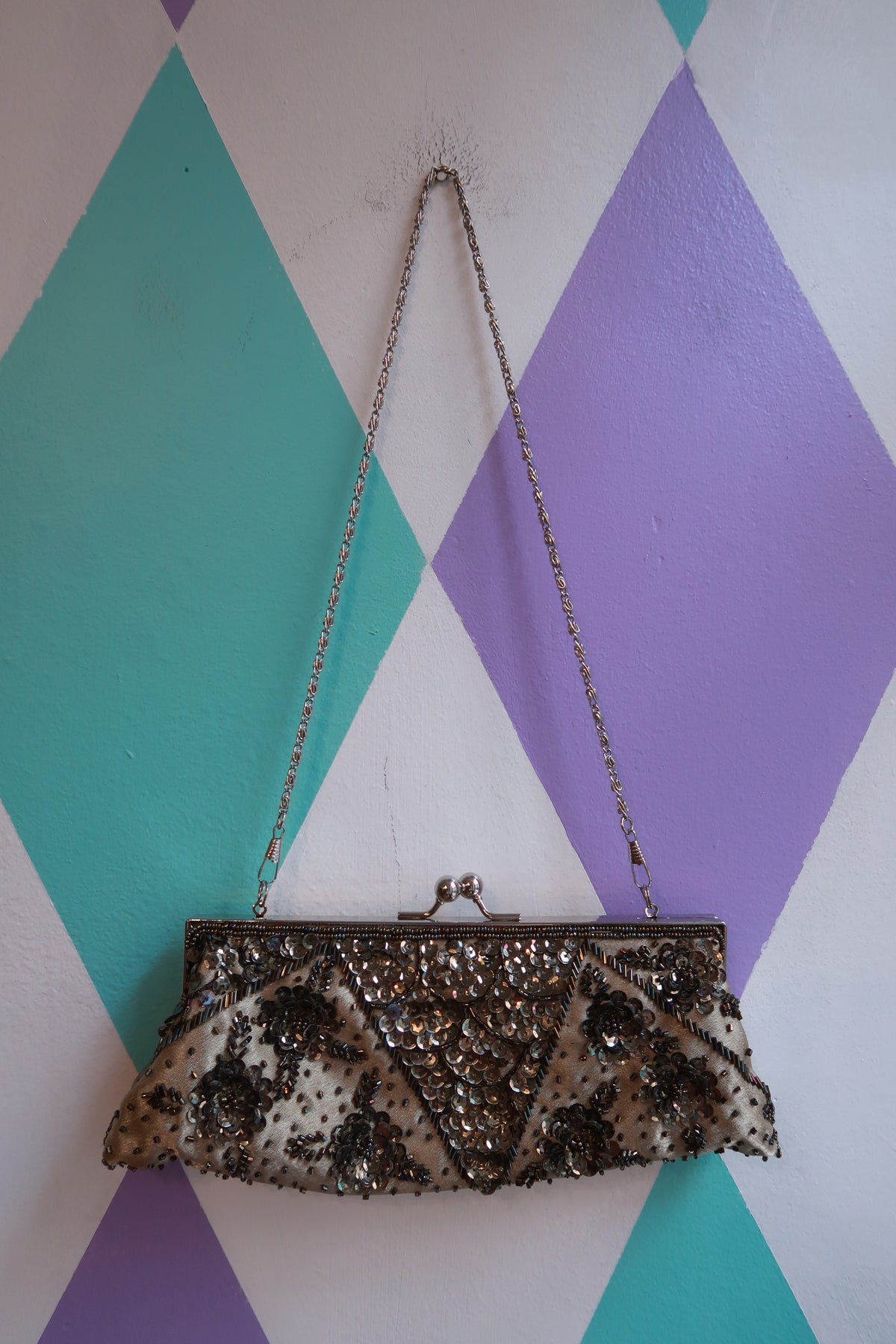 Vintage silver beaded evening clutch bag with sequin floral design and chain strap, by Elektra Vintage.