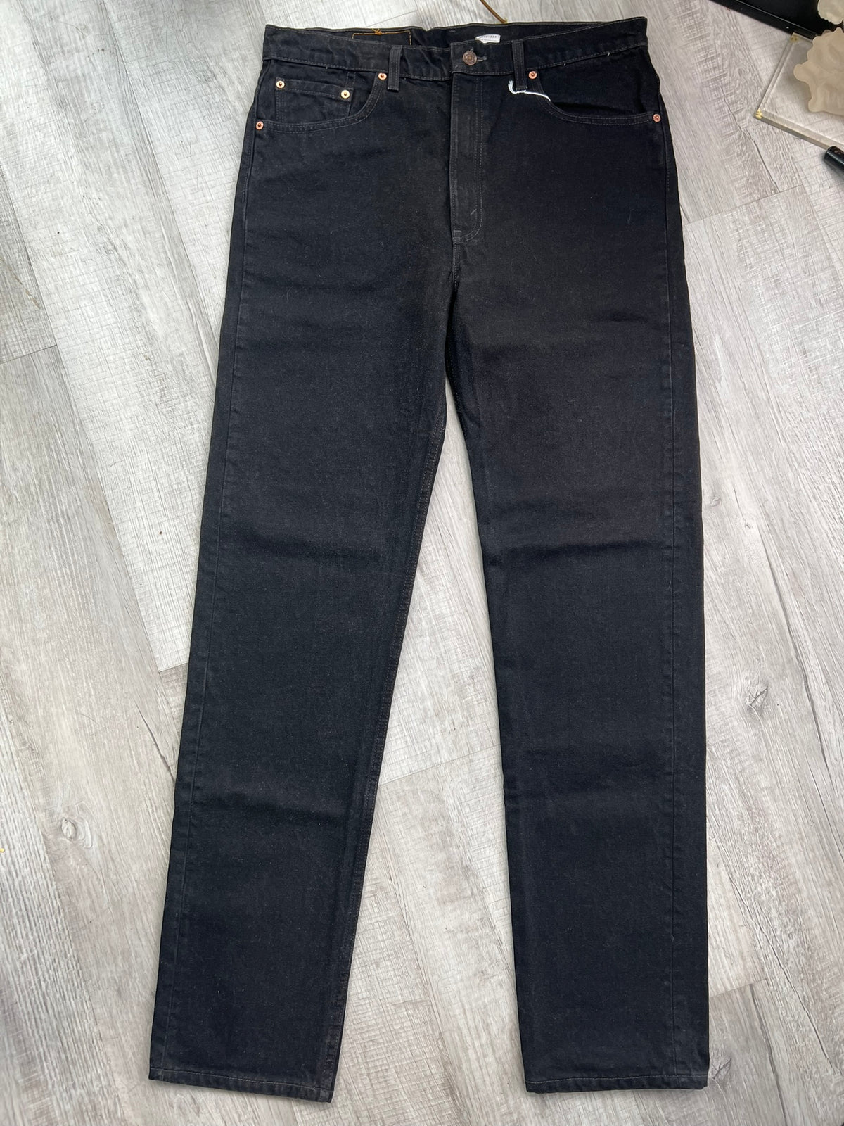 Men's Levi's 505 black denim straight fit jeans, vintage-style men's bottoms with classic straight leg cut and durable fabric.