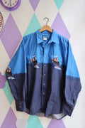 Men's vintage cowboy Western button-up shirt in blue by Elektra Vintage with classic snap buttons and detailed stitching.