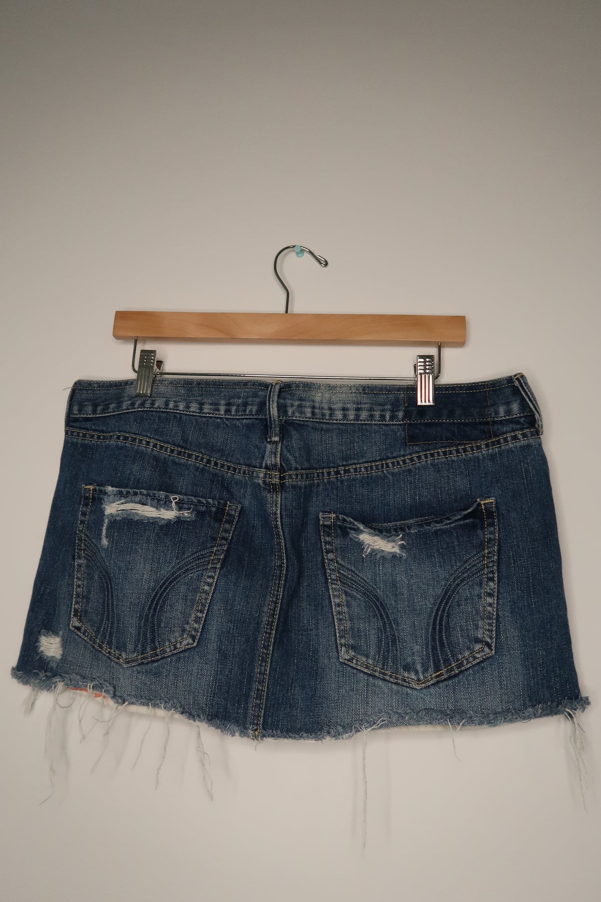 Vintage 2000s Hollister denim skirt by Elektra Vintage, high-waisted with classic blue wash and frayed hem detail.
