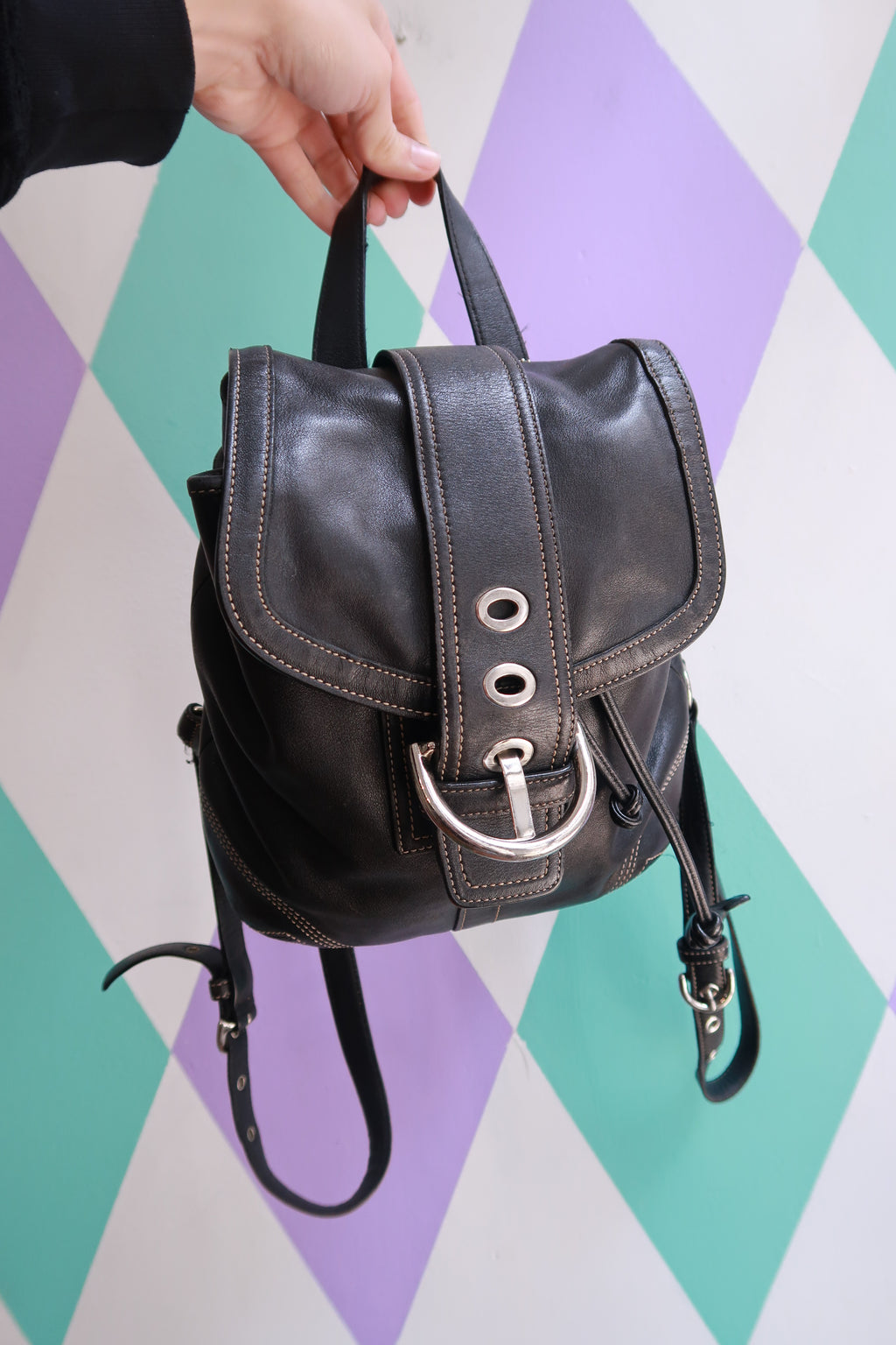 Vintage Coach Soho black leather backpack with drawstring closure, compact Y2K-style mini purse from Elektra Vintage.