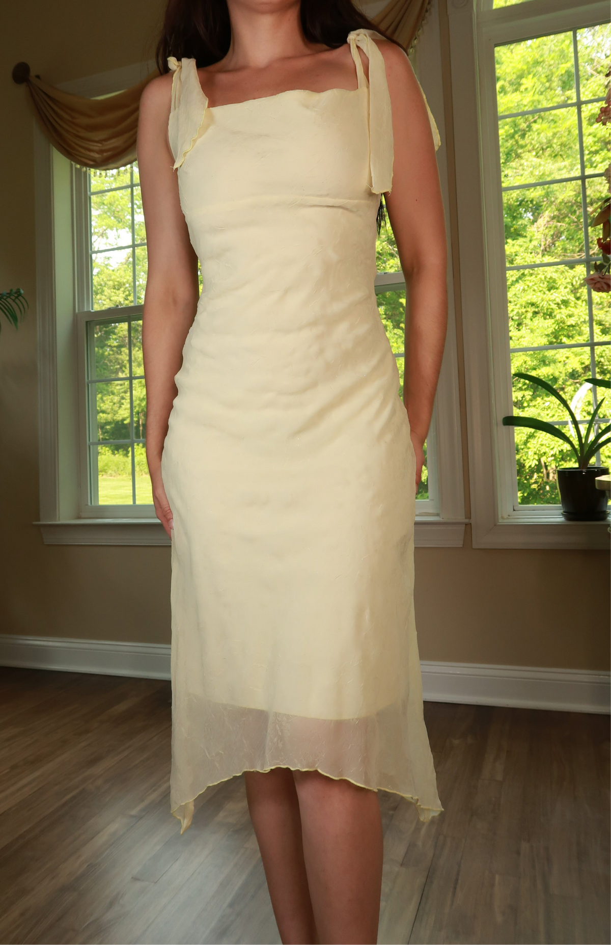 Vintage 2000s butter yellow tie strap midi dress by Elektra Vintage, featuring a fitted bodice and flowing skirt.