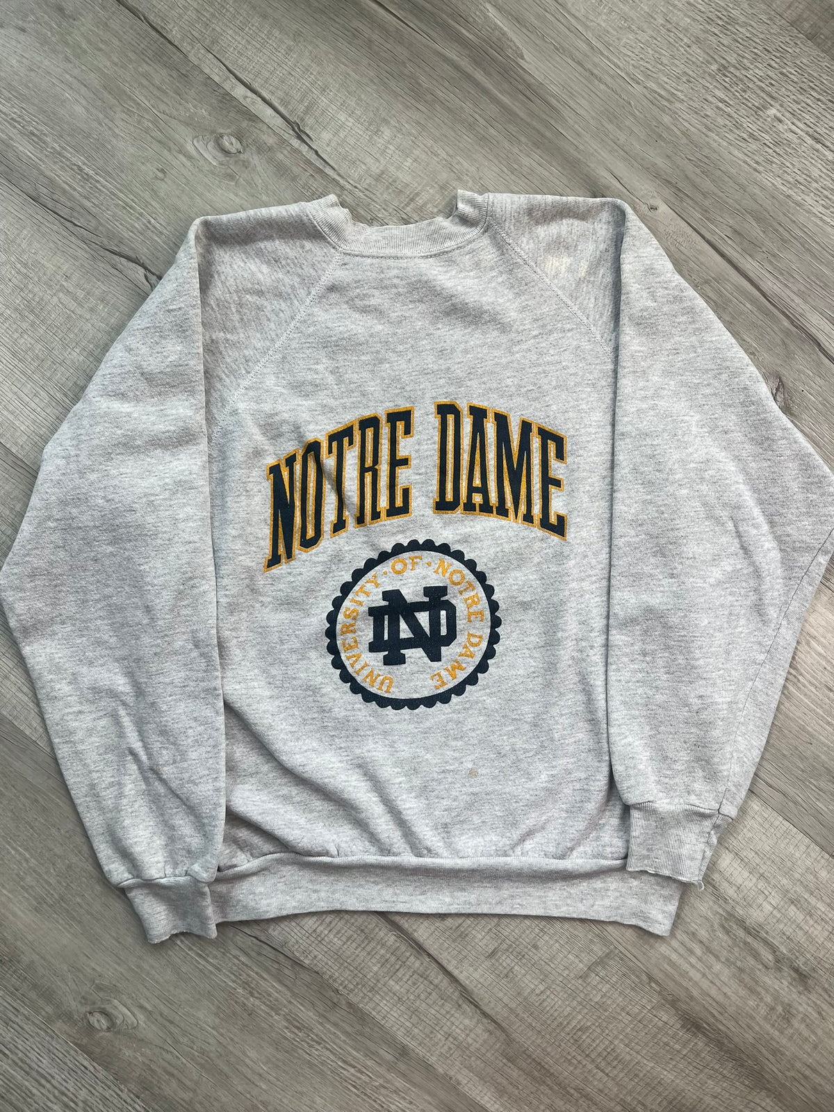 Vintage University of Notre Dame crewneck sweatshirt by Elektra Vintage, featuring university logo and classic collegiate style.