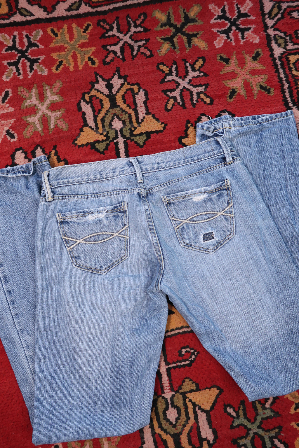 Elektra Vintage women's Y2K Abercrombie & Fitch distressed low-rise jeans with a relaxed fit and faded denim look.