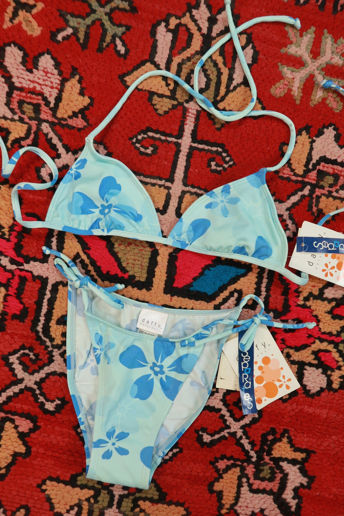 Vintage 2000s Elektra Vintage blue floral triangle bikini set with matching bottoms on a white background.