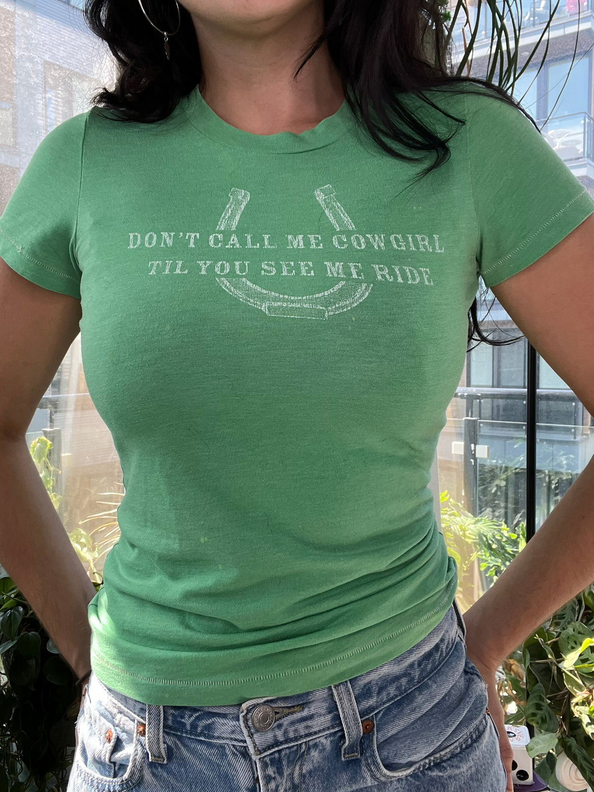 Vintage green cowgirl baby tee by Elektra Vintage, women's top featuring a playful cowgirl graphic and relaxed fit.