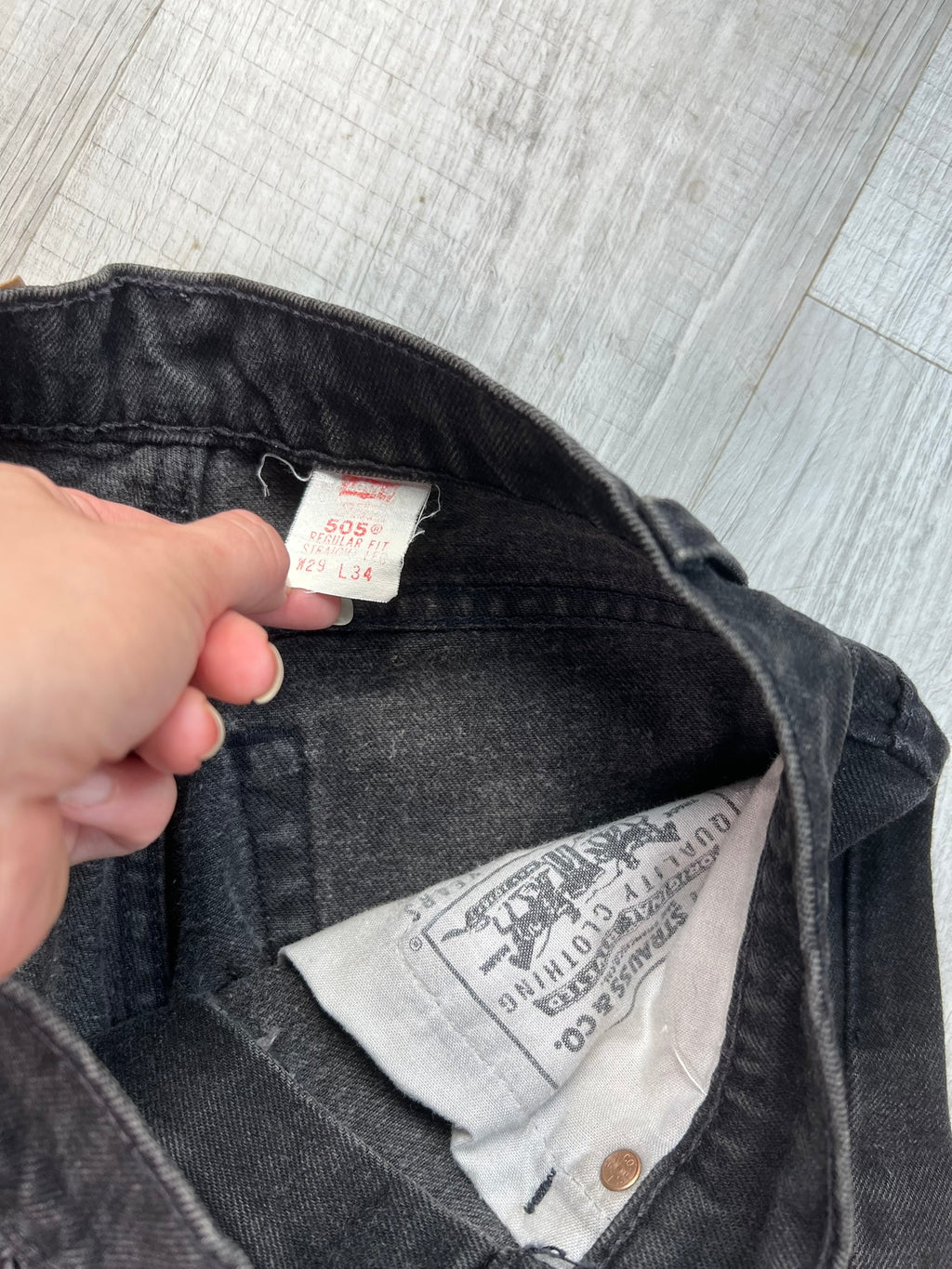 Vintage black Levi’s 505 jeans from Elektra Vintage, showing classic fit and distressed denim details.