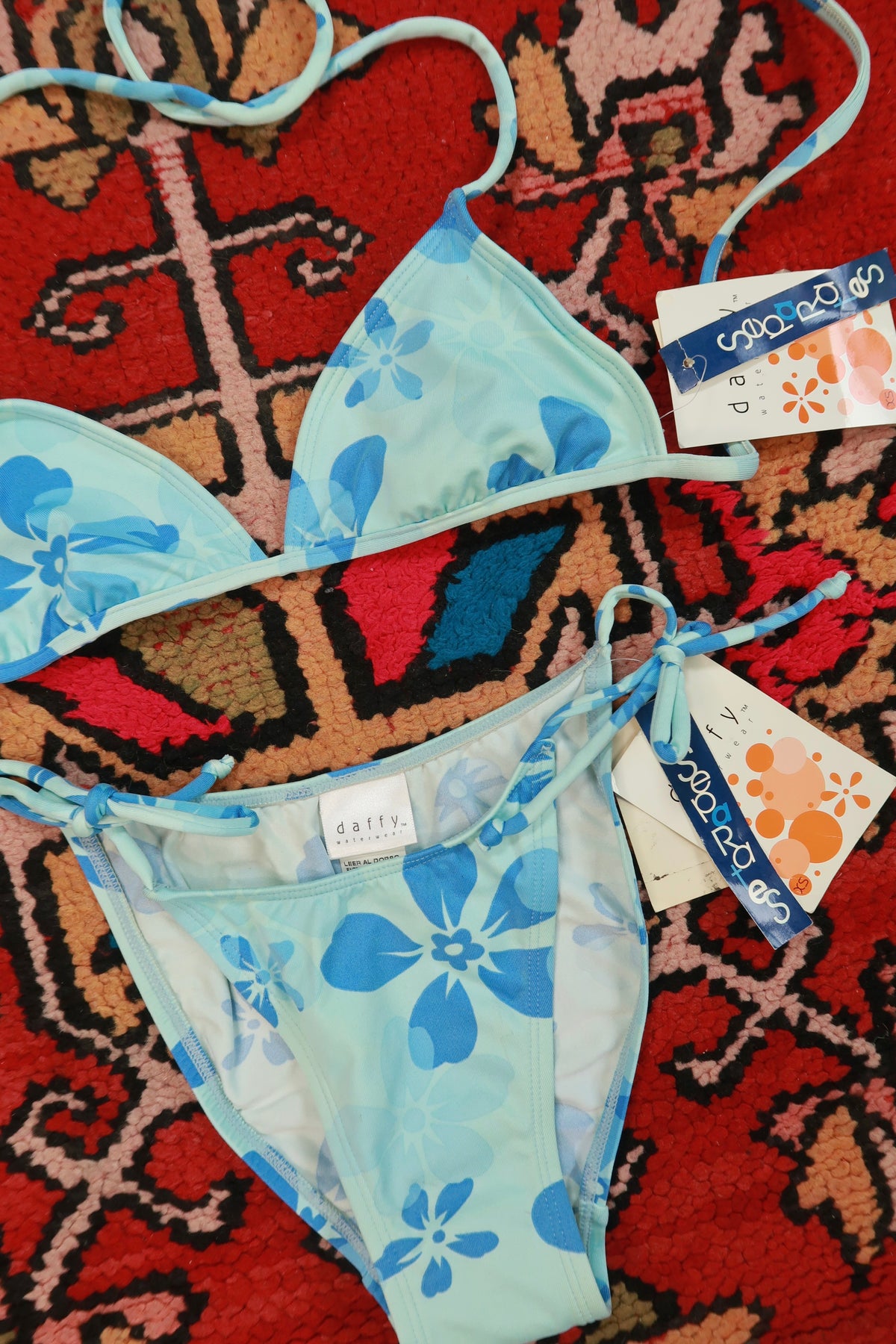Vintage 2000s Elektra Vintage blue floral triangle bikini set laid flat on white background.
