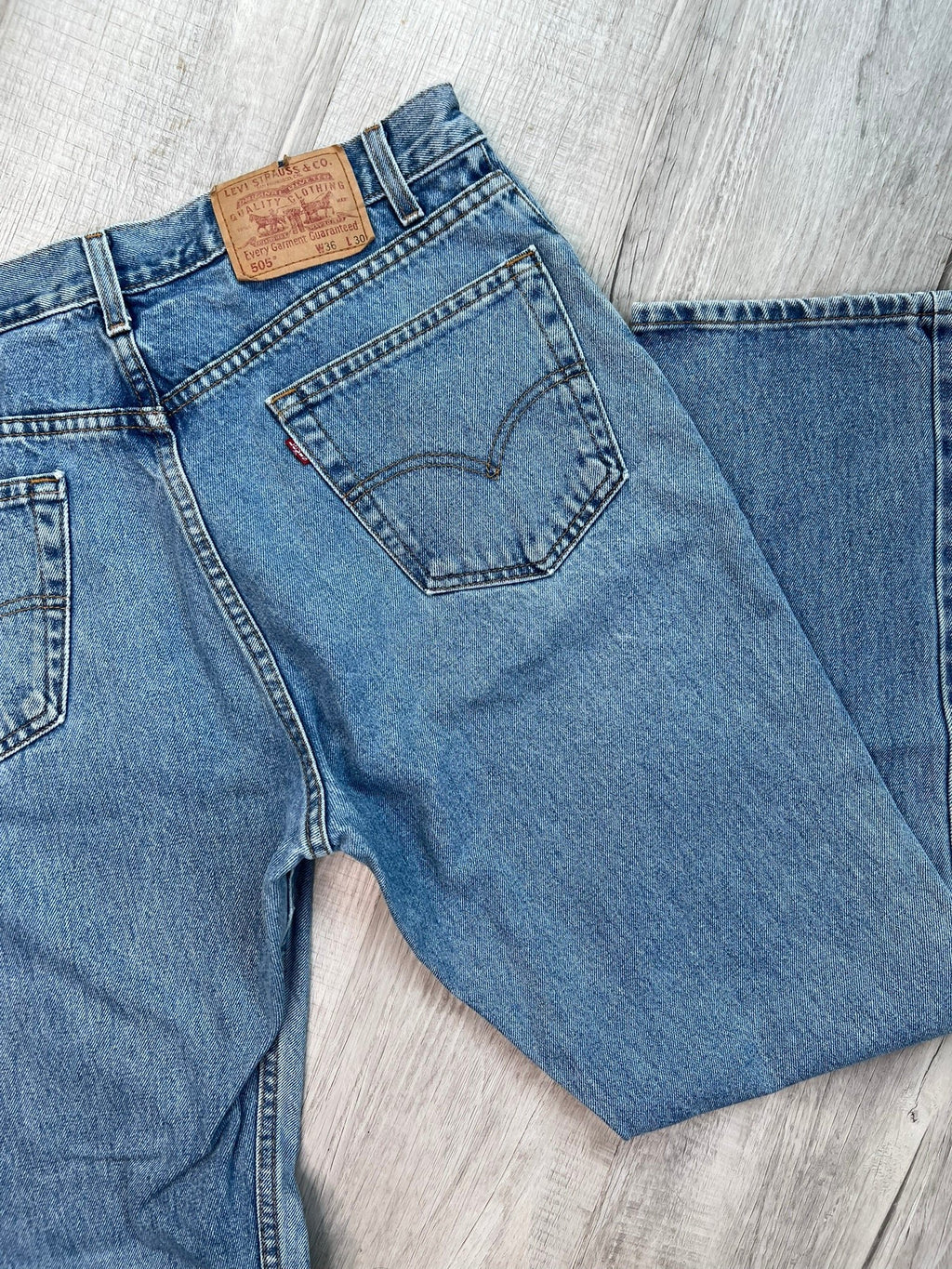 Men's Levi’s 505 regular fit straight leg jeans with medium wash and paint splatter detail, styled by Elektra Vintage.