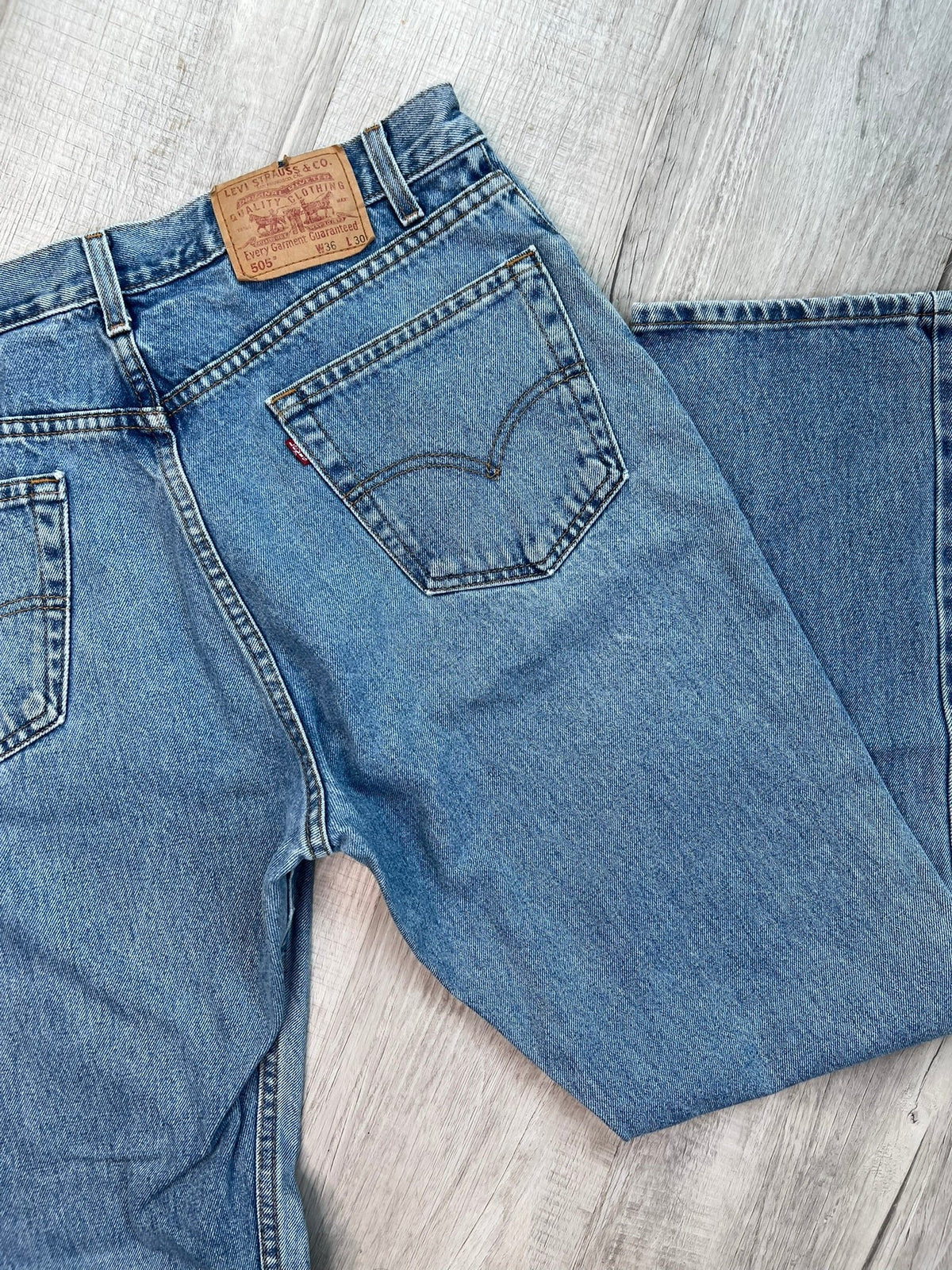 Men's Levi’s 505 regular fit straight leg jeans with medium wash and paint splatter detail, styled by Elektra Vintage.