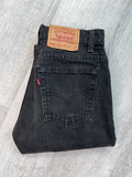 Vintage black Levi's 505 jeans from Elektra Vintage, displayed flat with detailed stitching and classic fit.