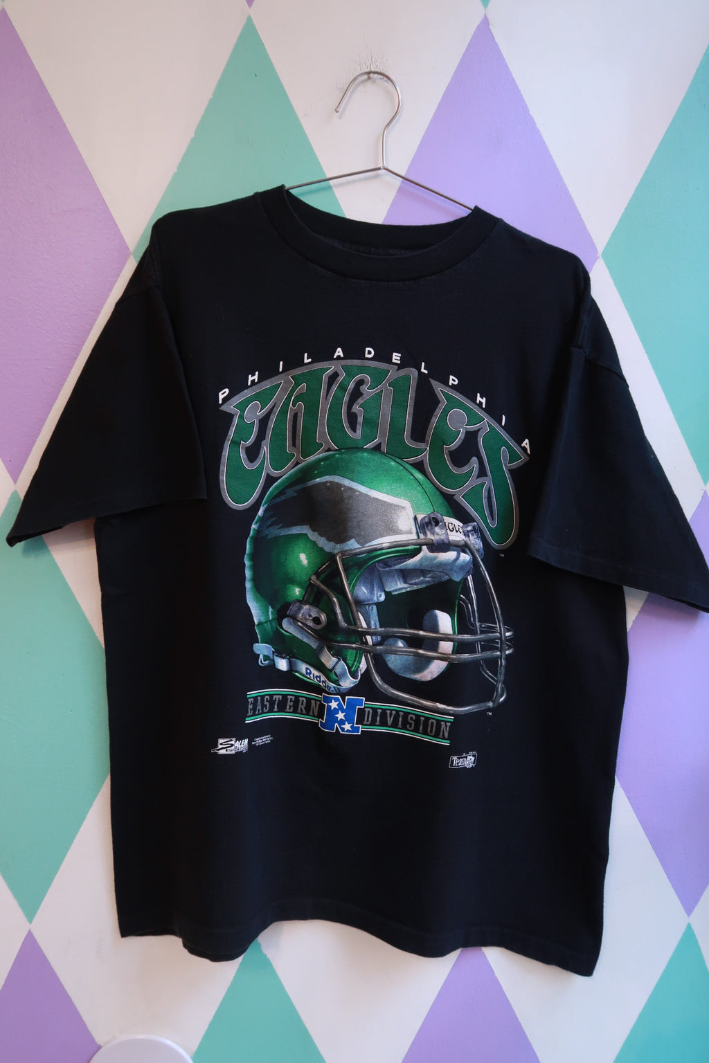 Black men's vintage 1991 Philadelphia Eagles football helmet graphic t-shirt by Elektra Vintage, casual NFL football shirt.