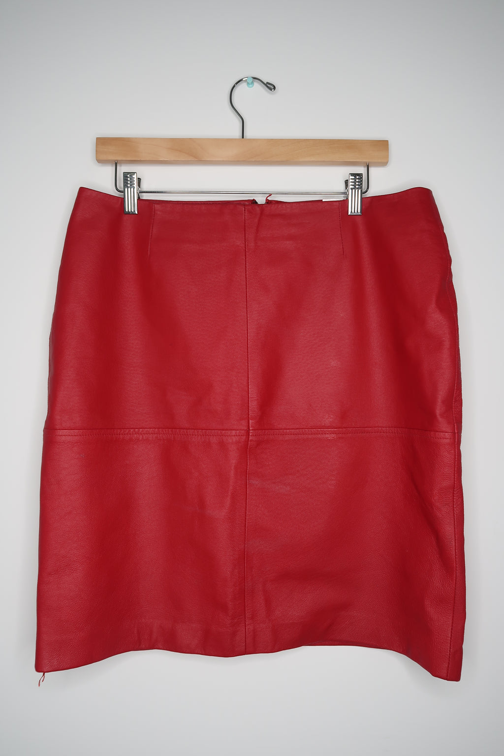 Vintage red leather skirt by Elektra Vintage, featuring a classic A-line design and smooth leather texture.