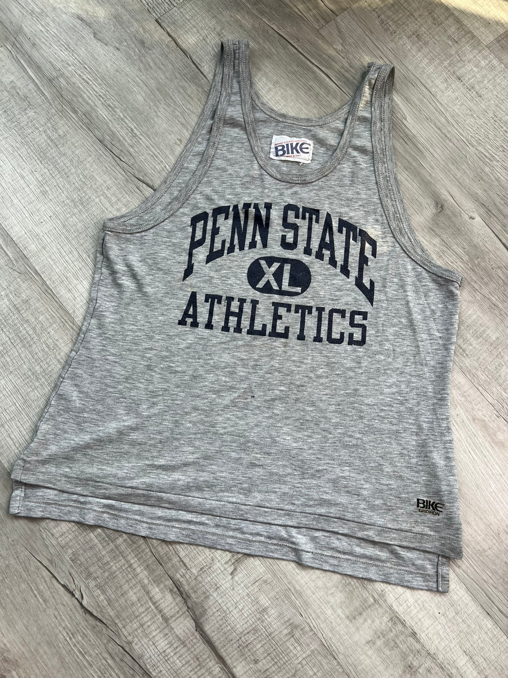 Vintage Penn State Athletics tank top by Elektra Vintage, featuring a classic logo and athletic design on soft fabric.