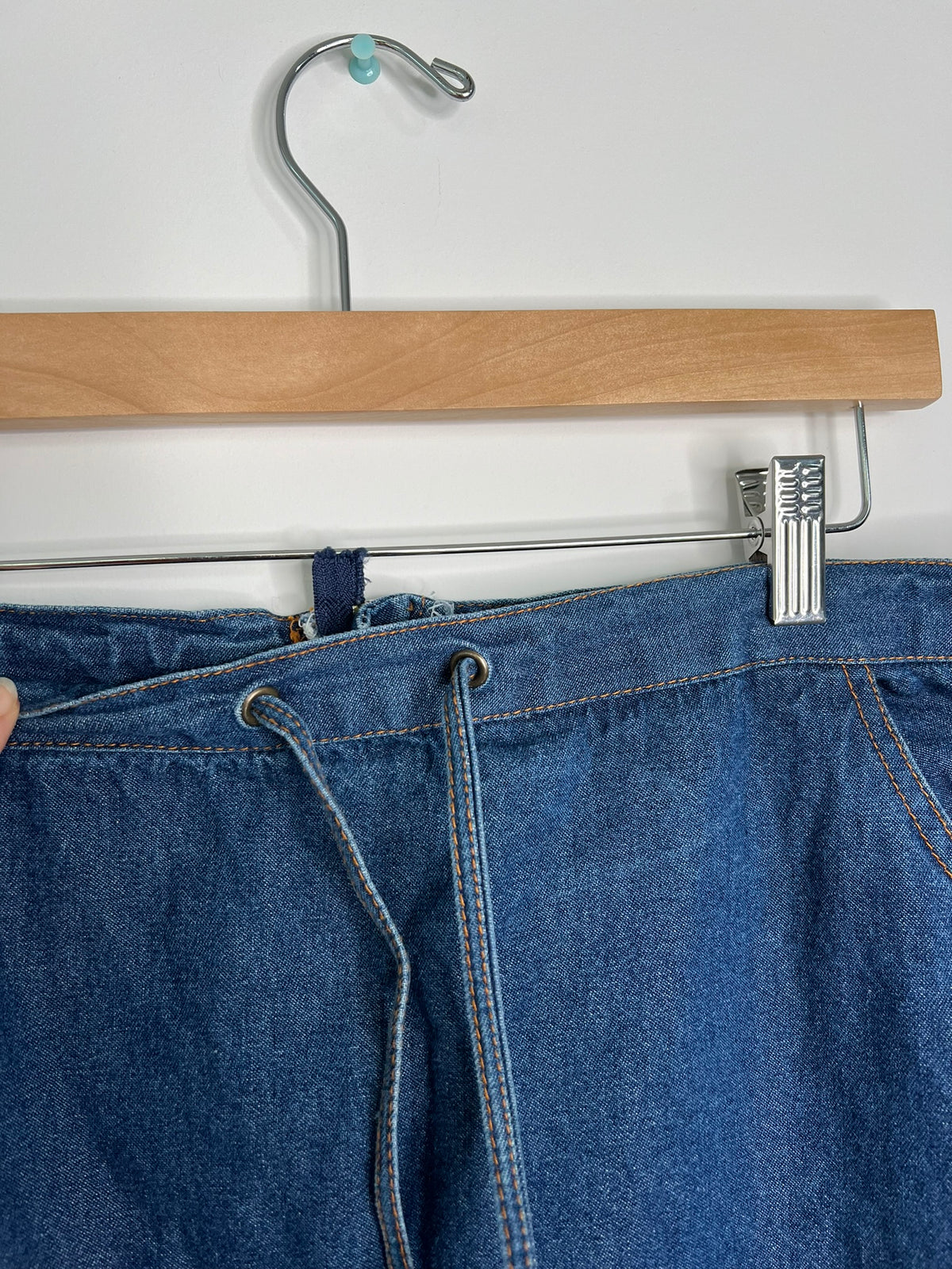 Vintage denim midi skirt by Elektra Vintage, featuring classic blue wash, high waist, and A-line silhouette.