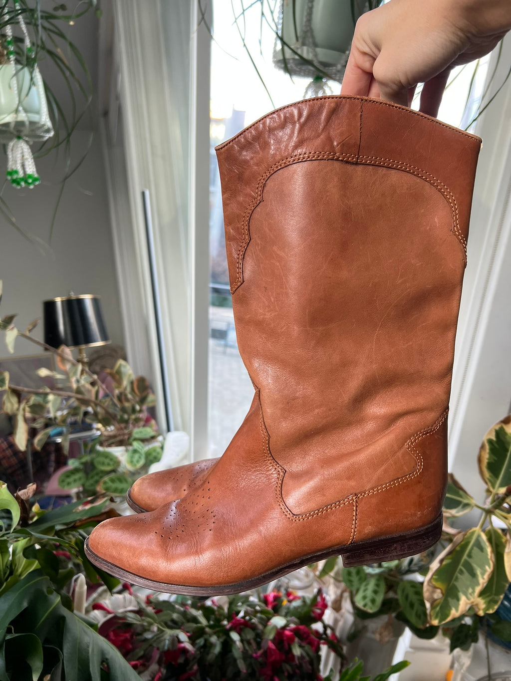 Vintage tan western cowboy boots by Elektra Vintage with pointed toes and decorative stitching on leather shaft.