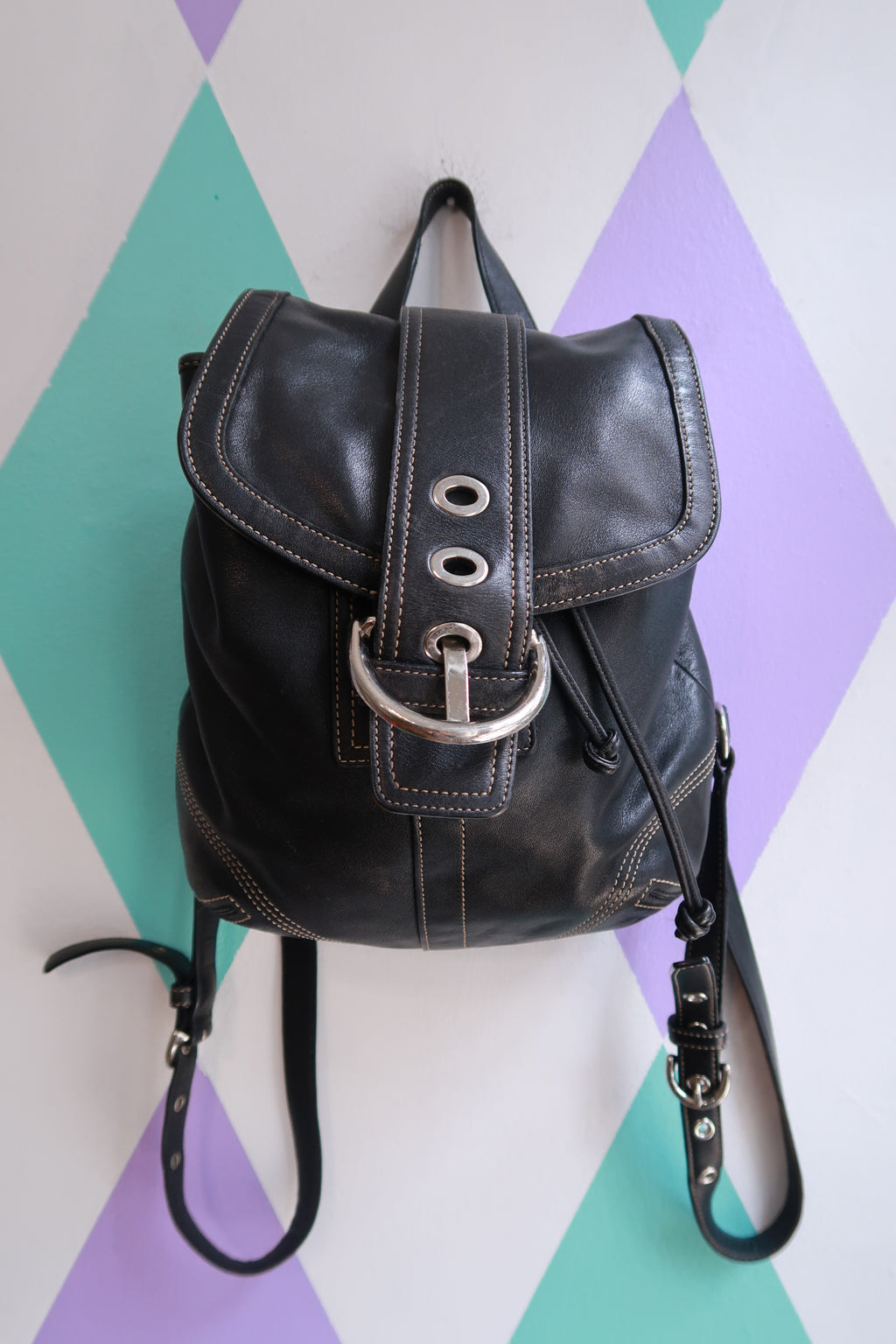Vintage Coach Soho black leather backpack by Elektra Vintage, Y2K drawstring mini bag with compact design and adjustable straps.