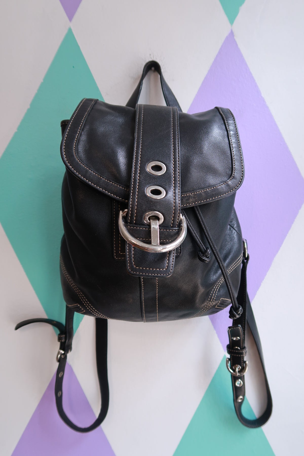 Vintage Coach Soho black leather backpack by Elektra Vintage, Y2K drawstring mini bag with compact design and adjustable straps.