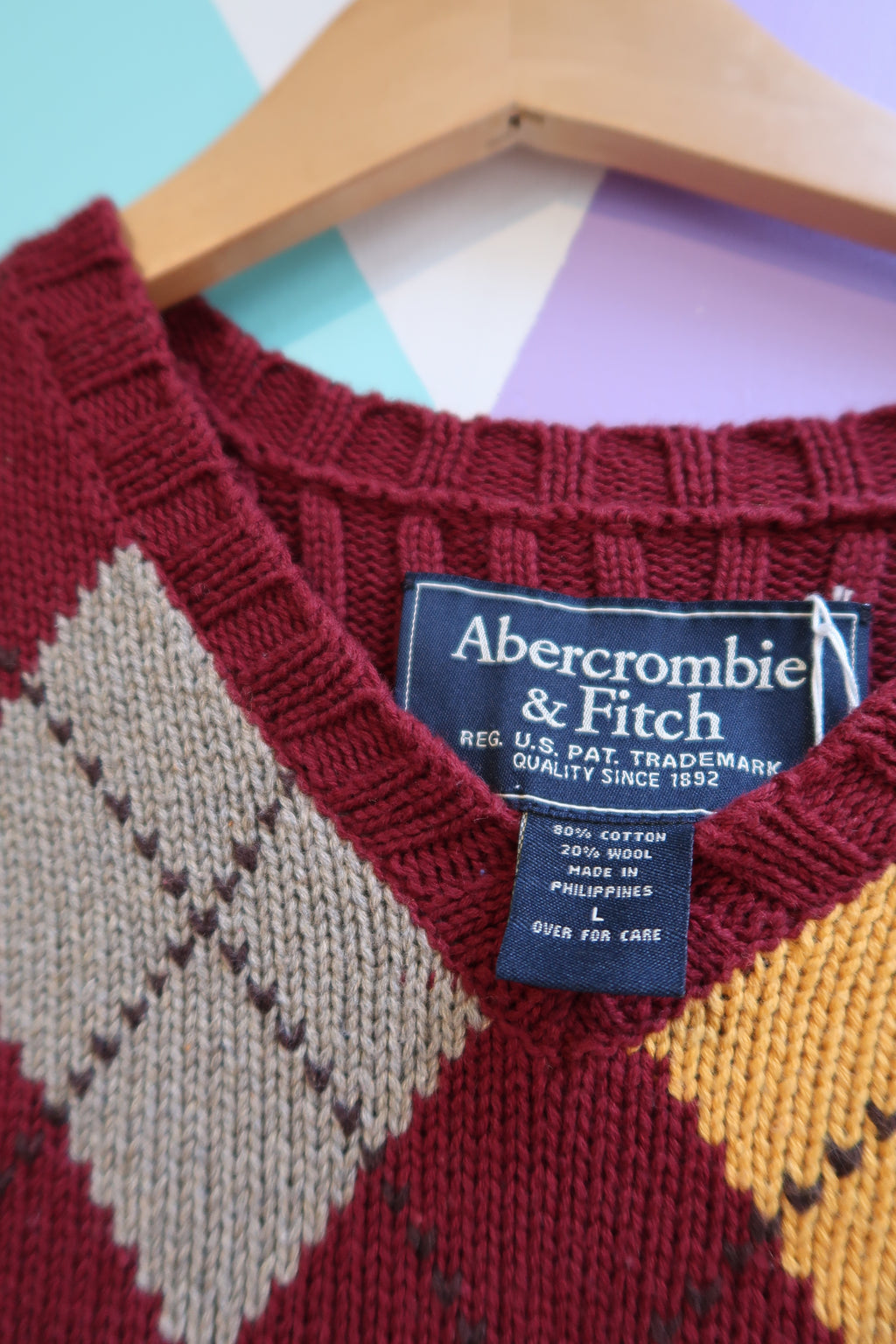 Elektra Vintage red and yellow argyle sweater vest by Abercrombie and Fitch, featuring a classic diamond pattern and ribbed detailing.