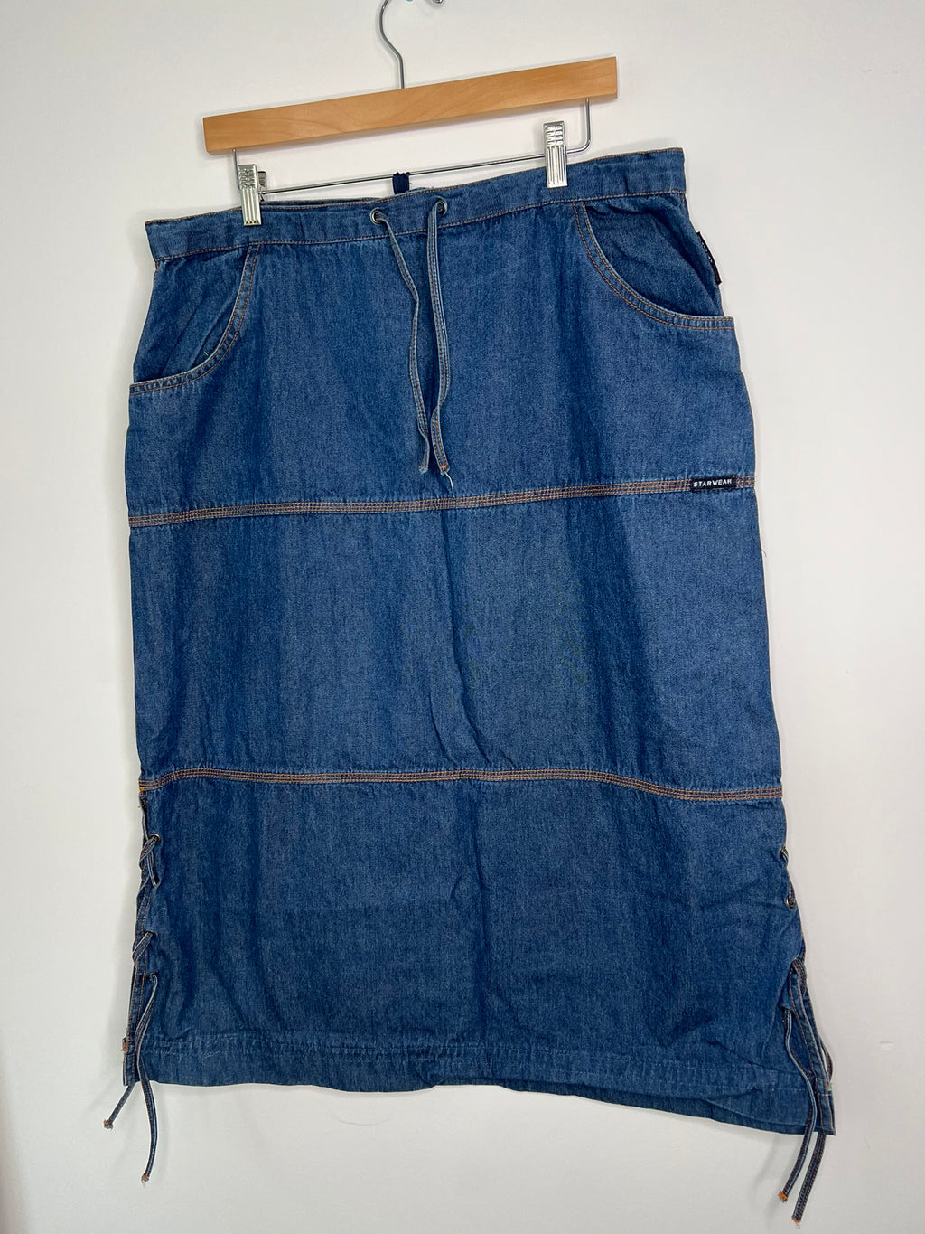 Vintage denim midi skirt by Elektra Vintage, featuring classic wash and high waist, displayed on a neutral background.