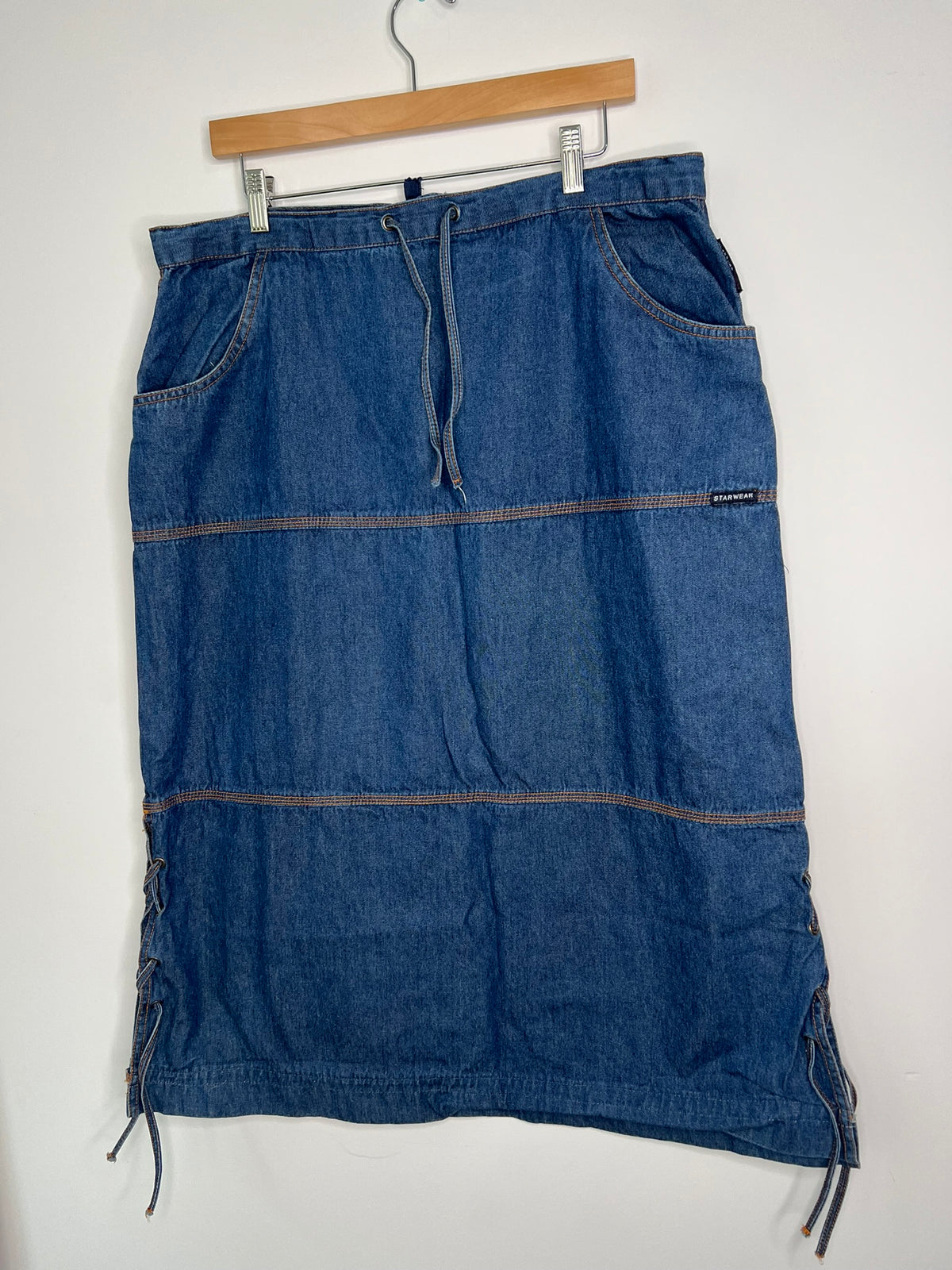 Vintage denim midi skirt by Elektra Vintage, featuring classic wash and high waist, displayed on a neutral background.