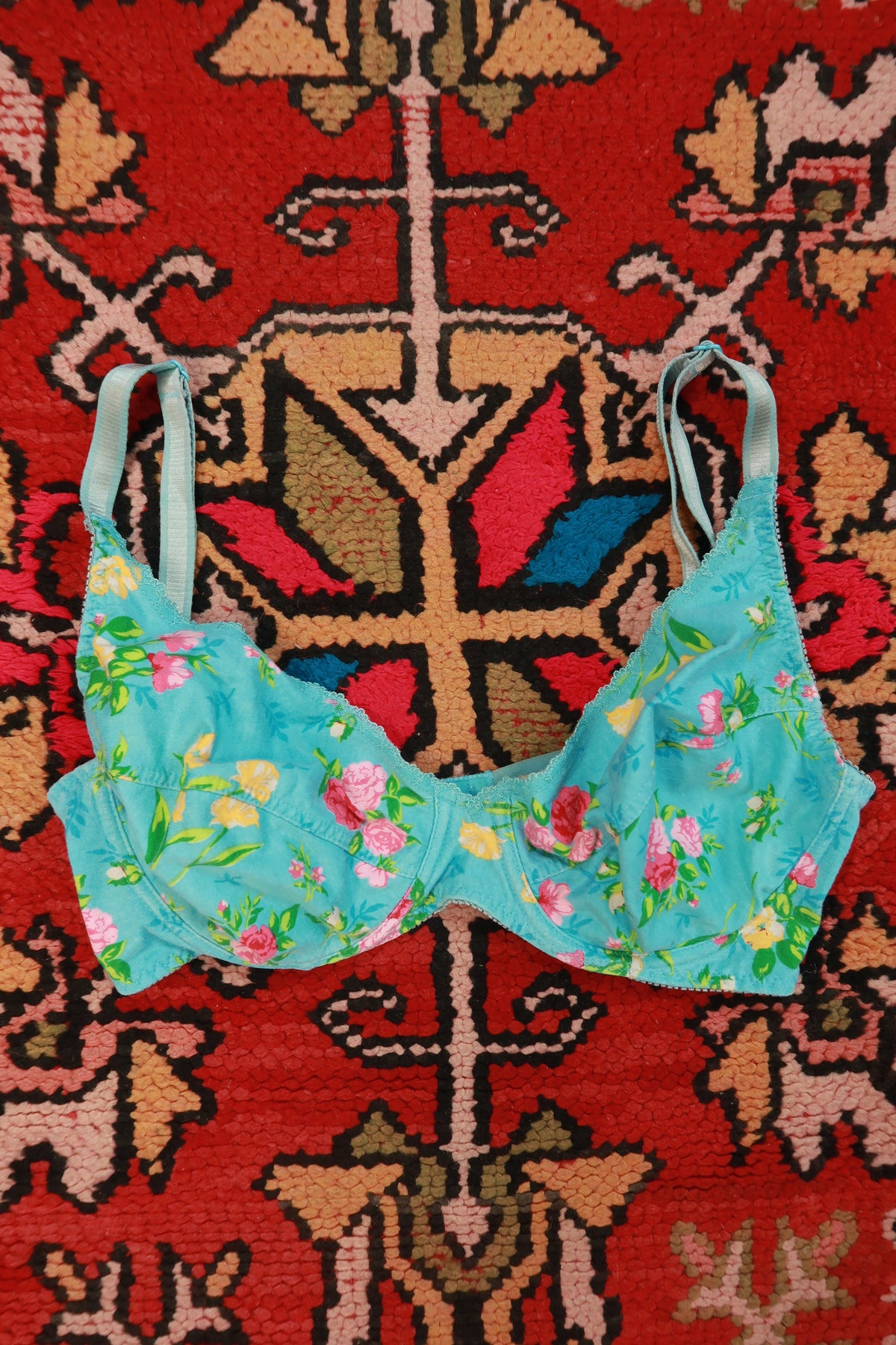 Vintage 2000s Victoria’s Secret blue floral cotton bra on a women's top display, showcasing feminine floral design and comfortable fabric.
