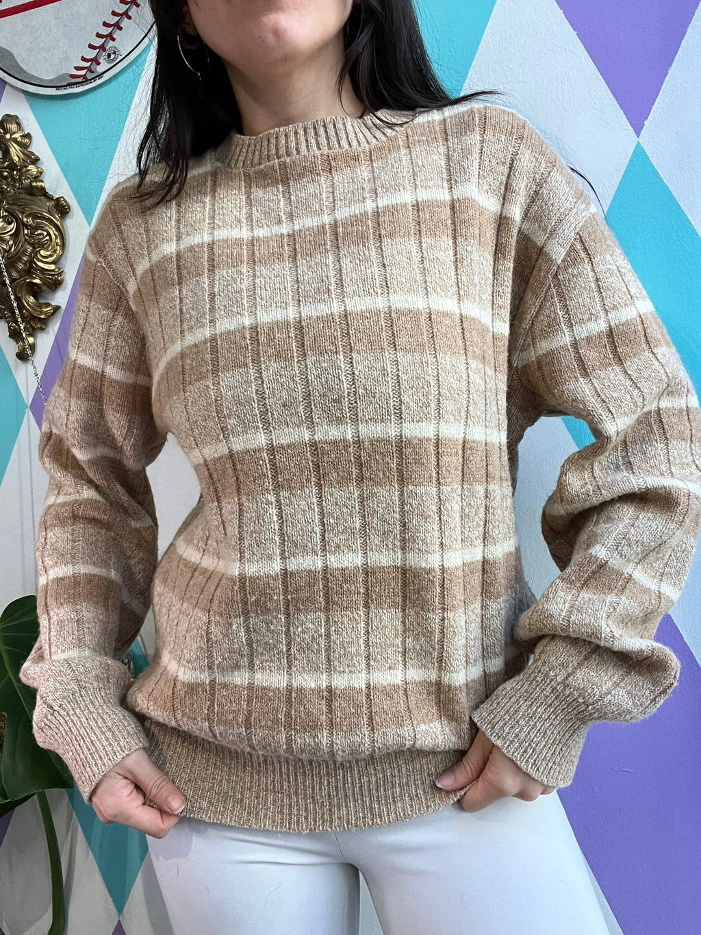 Vintage tan striped sweater by Jantzen, featuring a classic knit design, shown laid flat with ribbed cuffs and neckline.