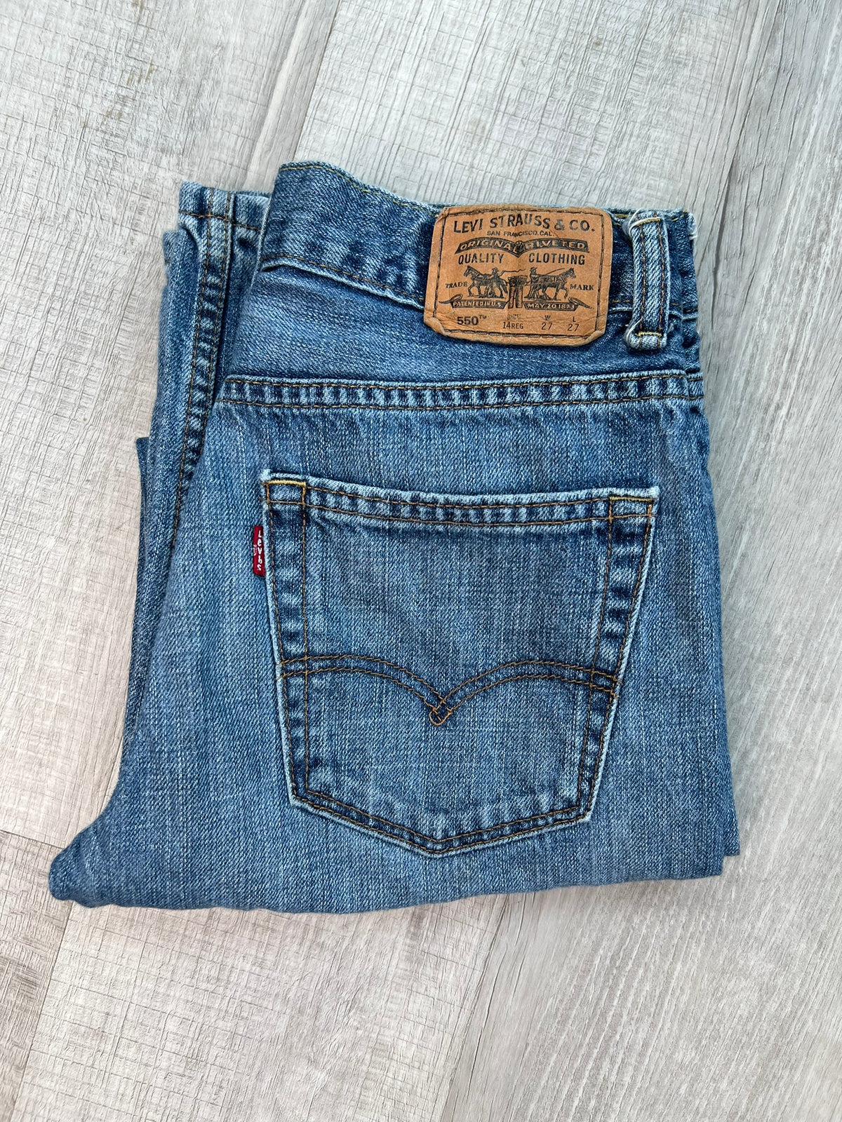 Women's Levi's 550 medium wash straight fit jeans, Elektra Vintage, showing classic denim style and straight leg cut.