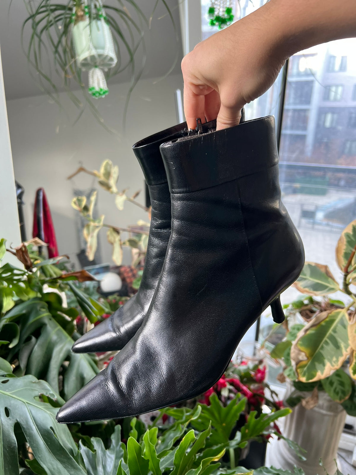 Vintage black leather pointed toe boots by Elektra Vintage, showcasing sleek design and stylish ankle-length silhouette.