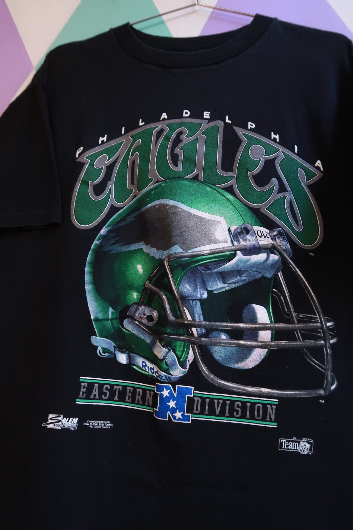 Men's black NFL football shirt featuring a vintage 1991 Philadelphia Eagles helmet graphic, by Elektra Vintage.