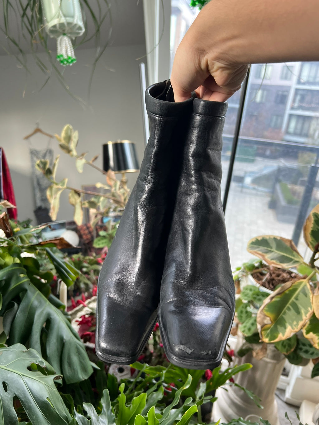 Vintage Stuart Weitzman square toe boots with leather finish and classic design, styled with mid-height heel and sleek silhouette.
