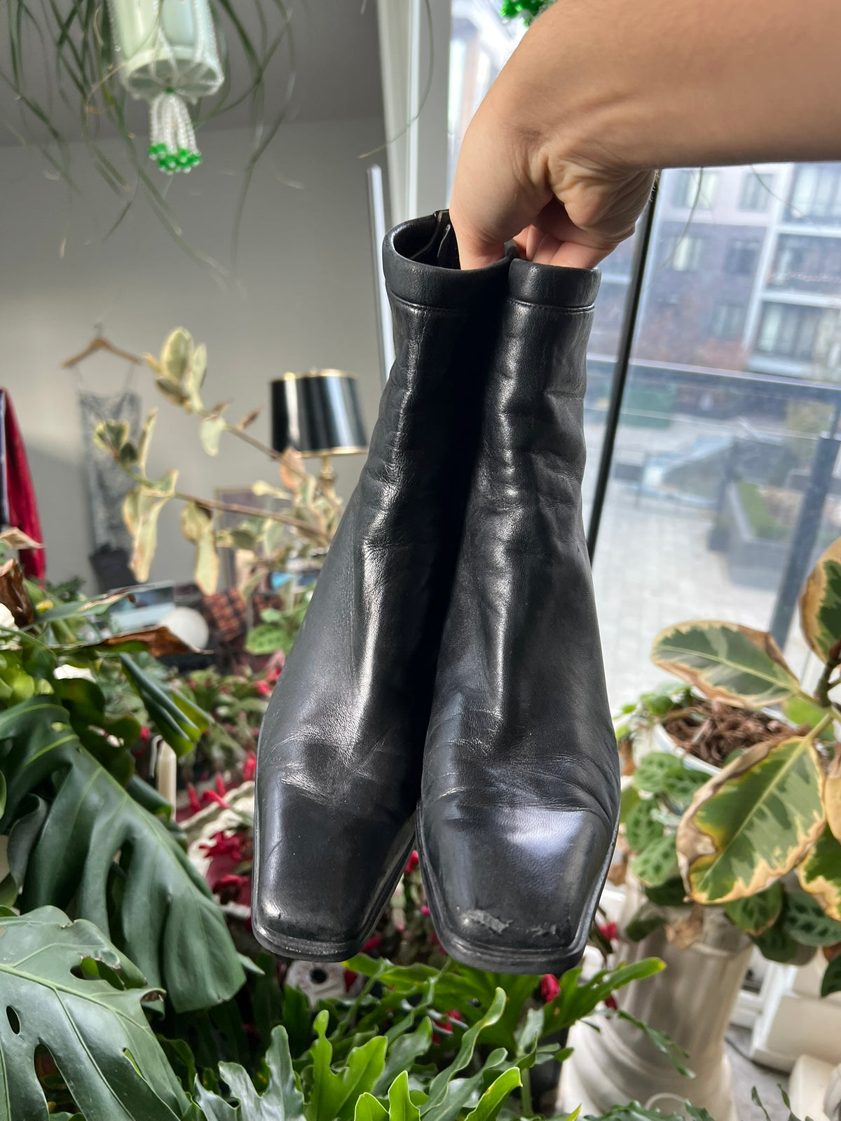 Vintage Stuart Weitzman square toe boots with leather finish and classic design, styled with mid-height heel and sleek silhouette.