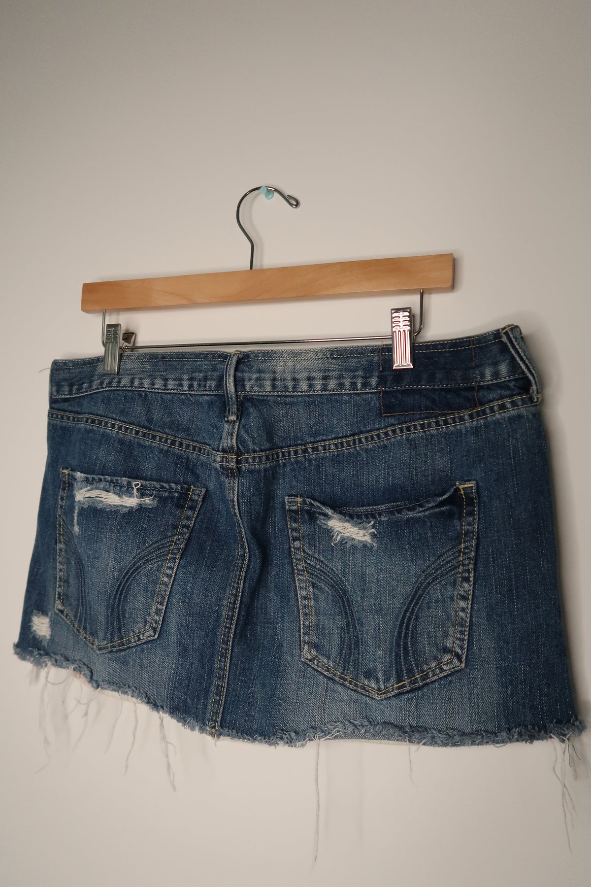 Vintage Hollister denim skirt by Elektra Vintage, high-waisted with classic 2000s style and distressed detailing.