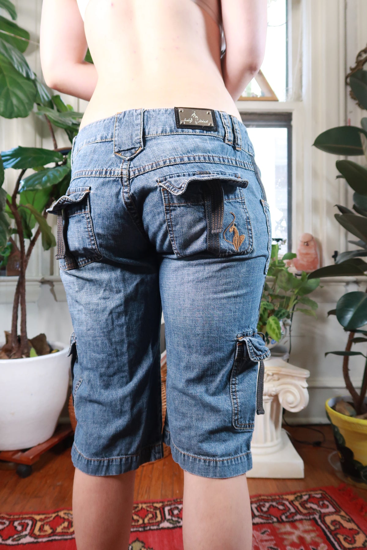 Women's vintage Baby Phat denim cargo capri pants by Elektra Vintage, showcasing classic 2000s style and casual comfort.