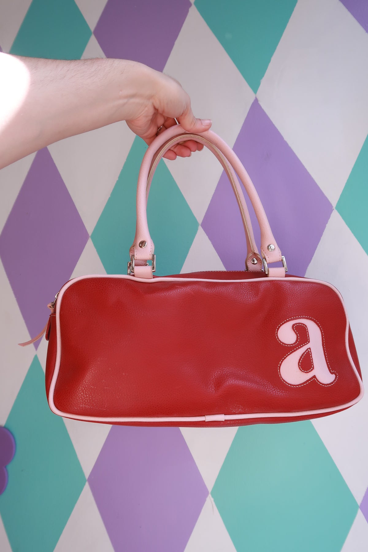 Vintage Y2K red mini bowling bag with pink trim from Elektra Vintage, featuring a compact purse design and stylish retro details.