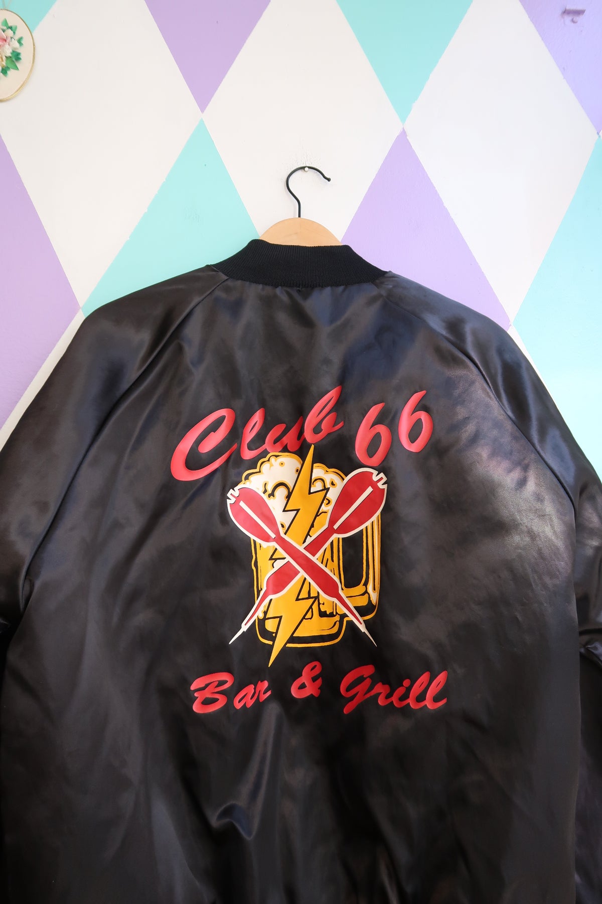 Elektra Vintage Vintage Club 66 Bar & Grill satin bomber jacket with ribbed cuffs and collar, black with logo patch on front.