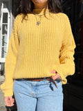 Vintage yellow oversized knit sweater by Elektra Vintage, featuring a cozy, chunky texture and relaxed fit on a mannequin.