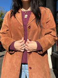 Elektra Vintage suede coat in classic vintage style, featuring a tailored fit and rich leather texture, displayed on a hanger.