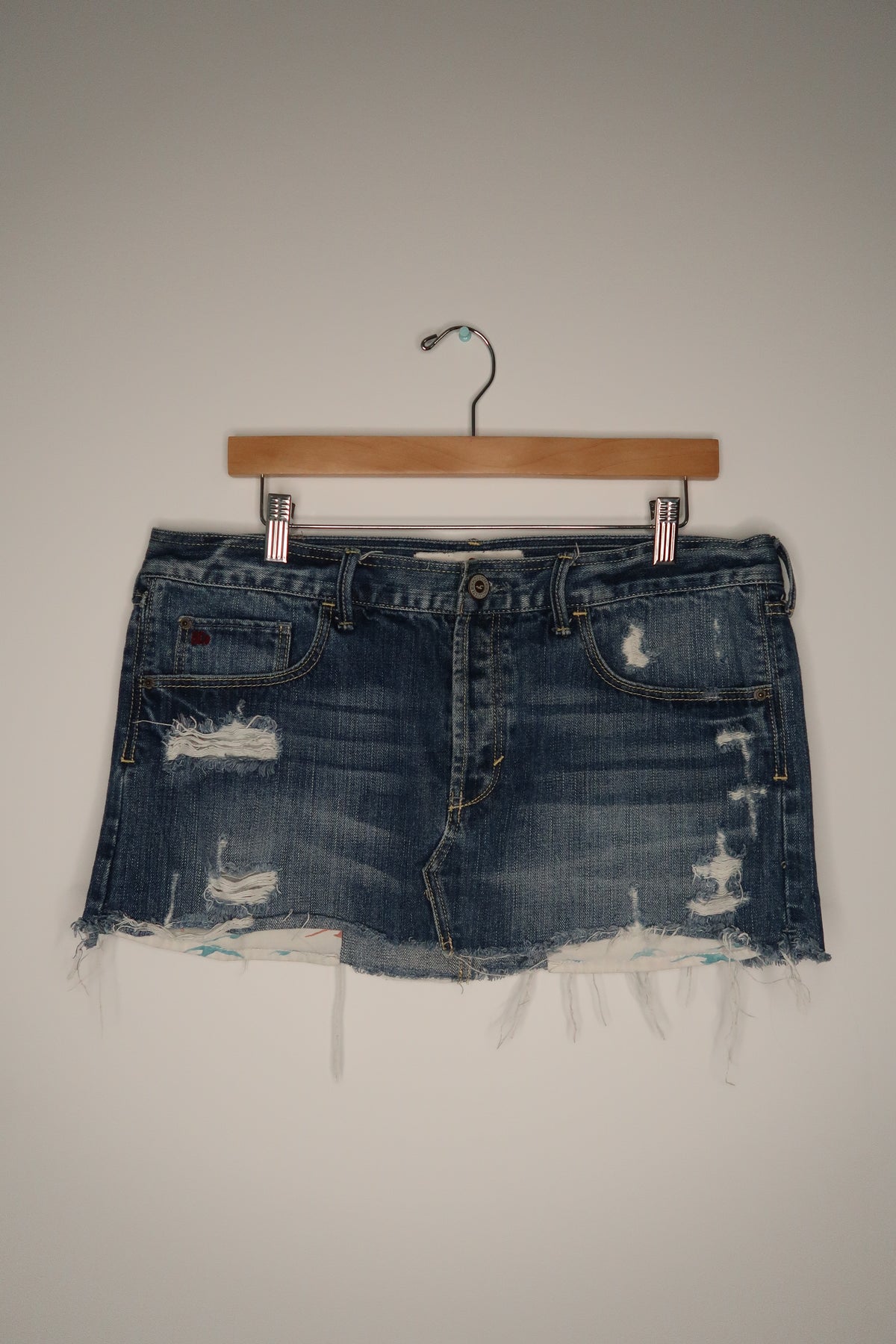 Vintage Hollister denim skirt from the 2000s, Elektra Vintage, featuring classic wash and casual style, shown on a hanger.