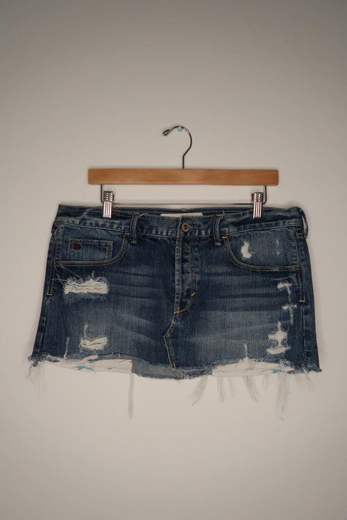 Vintage Hollister denim skirt from the 2000s, Elektra Vintage, featuring classic wash and casual style, shown on a hanger.