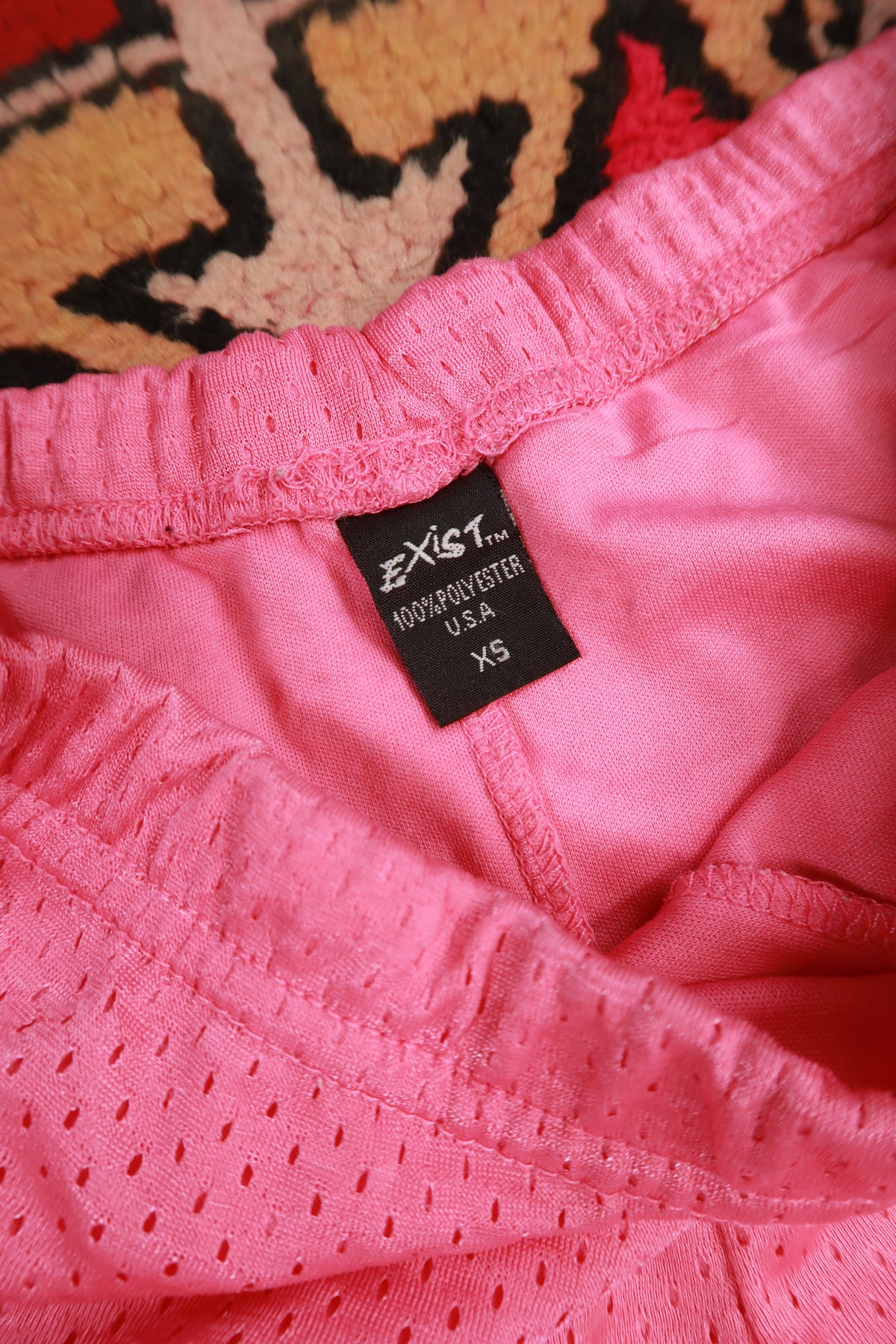 Pink vintage 2000s dice airbrush women's booty shorts by Elektra Vintage, featuring bold retro graphic design.