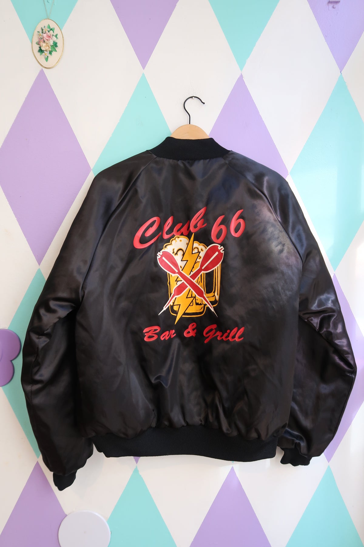 Vintage Elektra Vintage Club 66 Bar & Grill satin bomber jacket with ribbed cuffs and collar, featuring embroidered logo details.