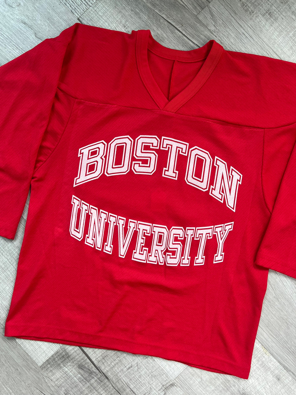 Vintage Boston University hockey jersey by Elektra Vintage, featuring classic team logo and retro design on white fabric.