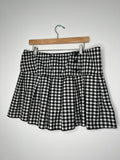 Vintage 2000s pleated gingham skirt by Elektra Vintage, showing a high-waisted design with classic red and white checkered pattern.