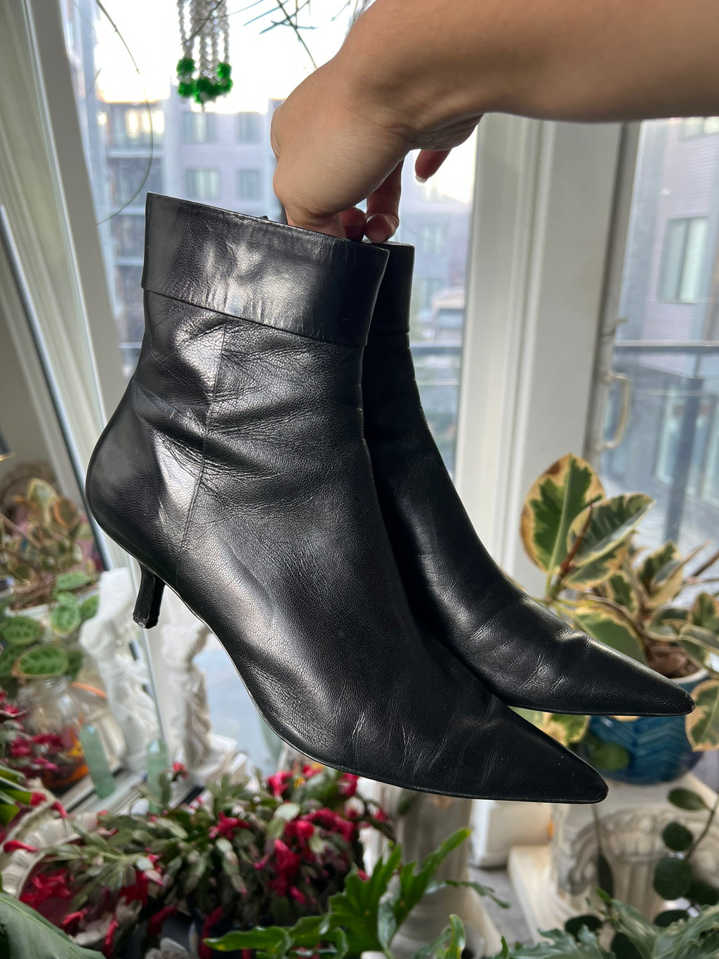 Vintage black leather pointed toe boots by Elektra Vintage featuring sleek design and classic silhouette.
