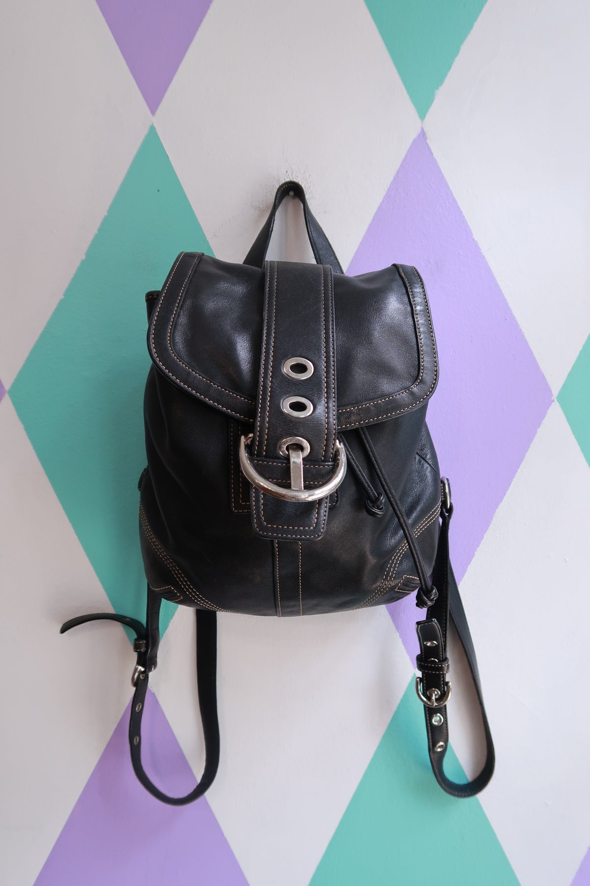 Vintage Coach Soho black leather backpack by Elektra Vintage, Y2K drawstring mini purse with adjustable straps and classic bag design.